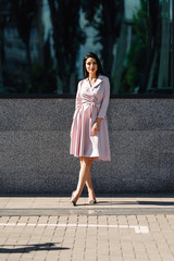 Fototapeta premium Attractive brunette in dress outdoors in spring