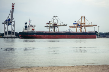 Bulk carrier ship in Swinoujscie, coastal city over Baltic Sea in Poland