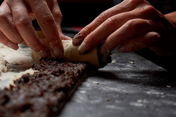 Baker prepares homemade cakes. Professional Female cook sprinkles dough with flour, prepared for baked bread