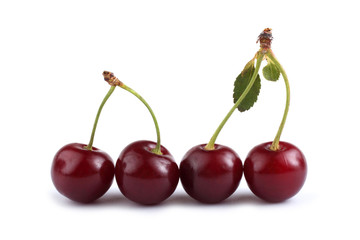 Cherries and leaves isolated on white background