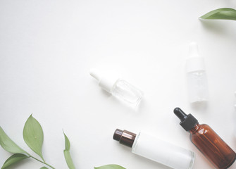 Bottles of aromatic oil with petals on the background. Basics of aromatherapy. Botanical skin care at home Spa treatment. Top view. natural medicine