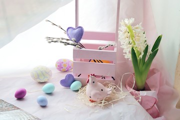 Happy Easter, colored eggs, blooming hyacinth in a pot on the windowsill, spring, holiday decor