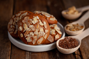 Almond Chip Cookies. Almonds on a round homemade cookie. Still life, food closeup on a wooden table. Appetizing pastries.