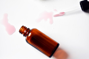 Various glass bottles for cosmetics, natural medicine , essential oils or other liquids on a white background, top view. Organic