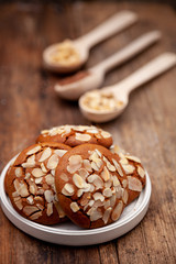 Almond Chip Cookies. Almonds on a round homemade cookie. Still life, food closeup on a wooden table. Appetizing pastries.