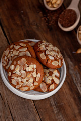 Almond Chip Cookies. Almonds on a round homemade cookie. Still life, food closeup on a wooden table. Appetizing pastries.