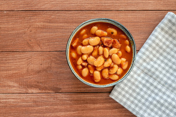 Beans stew with sausages in a bowl