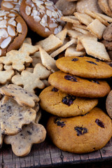 A set of different homemade cookies. Cookies close-up. Background from delicious pastries. Cookie with coconut, mishdal, chocolates, raisins, lingonberries. Round, rhombuses, bears, flowers shapes.