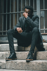 Black businessman siting in the stairs