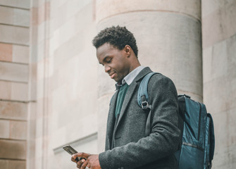 black man with smartphone in the city