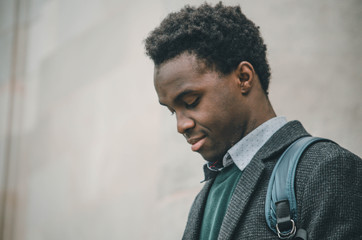 Young black student looking at his smartphone