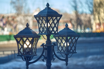 old light posts in the city with blurred background