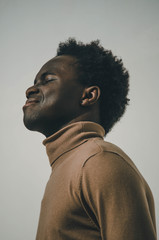Young and black man smiling and enjoying the sun