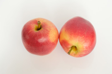 two red apples on a white background