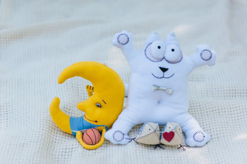 Wedding details for weddings and newlyweds: a pillow with a heart, a soft toy of the month with a basketball and a gray funny cat on a white background. Photography, concept.