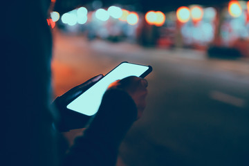 Traveler woman using mobile phone in night city