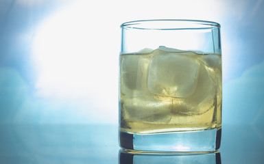 glass of whiskey with ice on a white background