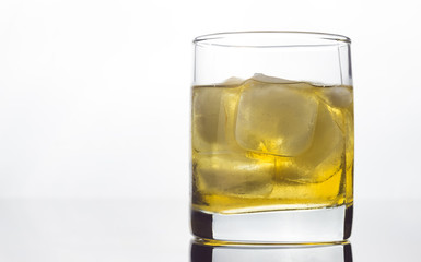 glass of whiskey with ice on a white background