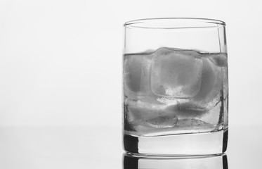 glass of whiskey with ice on a white background