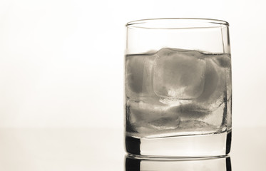 glass of whiskey with ice on a white background