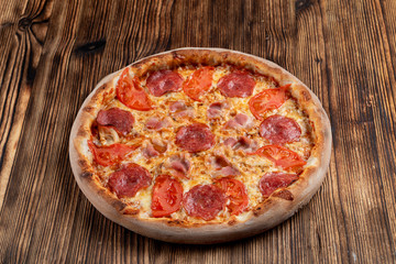 Italian meat pizza with bacon, salami, pepperoni and chicken, seasoned with jalapeno sauce