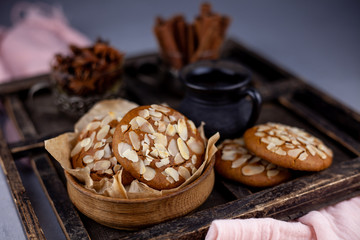 Almond Chip Cookies. Almonds on a round homemade cookie. Still life, food closeup on a wooden table. Appetizing pastries.