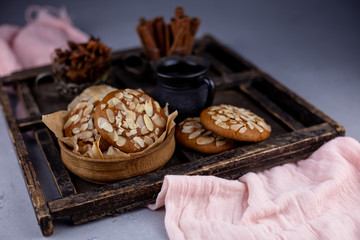 Sweet almond cookies  on wooden table.French homemade cookie. Useful Lenten cookies from almond flour with honey on rustic wooden background. Selective soft focus.