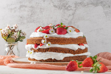 Strawberry cake, strawberry sponge cake with fresh strawberries and sour cream on a white background