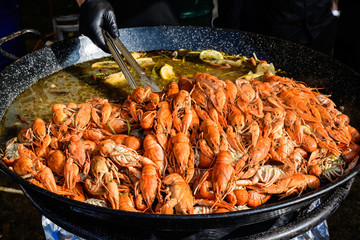 European crayfishes Astacus astacus (noble or broad-fingered crayfish, the most common species of crayfish in Europe) in a pan cooked at a street food festival, ready to eat healthy seafood 