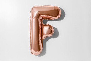 Letter F, Rose gold foil balloon alphabet isolated on white background with Clipping Path