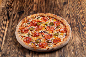Hot chorizo pizza with chorizo sausage, jalapenos and bell pepper on a table in italian restaurant