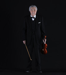 old man with a violin on a black background