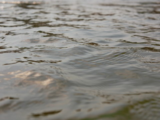 Close up and selective focus of flowing river surface