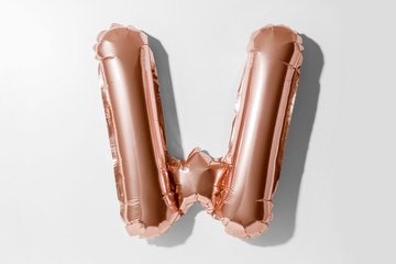 Letter W, Rose gold foil balloon alphabet isolated on white background with Clipping Path