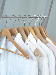 Storage of white and light items on the shoulders of hangers, products made of natural fabrics