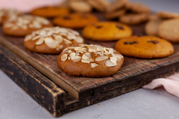 Sweet almond cookies  on wooden table.French homemade cookie. Useful Lenten cookies from almond flour with honey on rustic wooden background. Selective soft focus.