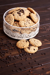  Dietary cookies with dark chocolate on a wooden background.