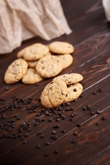  Dietary cookies with dark chocolate on a wooden background.