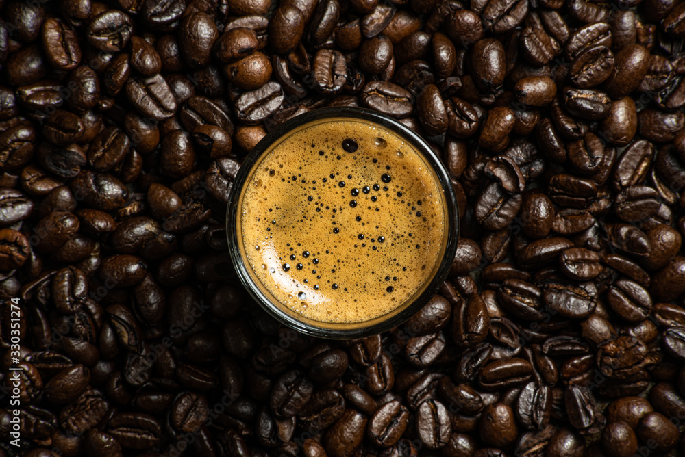 Wall mural close up of coffee beans against rustic background