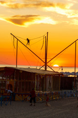 Attraction for jumping in the air on a trampoline at sunset.