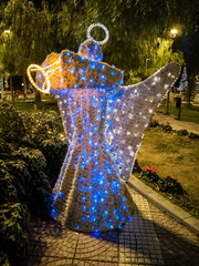 A luminous figure of an Angel in the city of Athens at Christmas