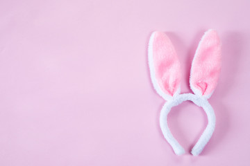 pink bunny ears over wooden table