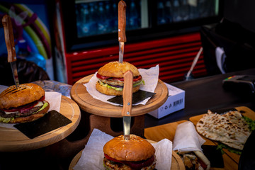 Beef burgers being served on food stall on open kitchen international food festival event of street food.