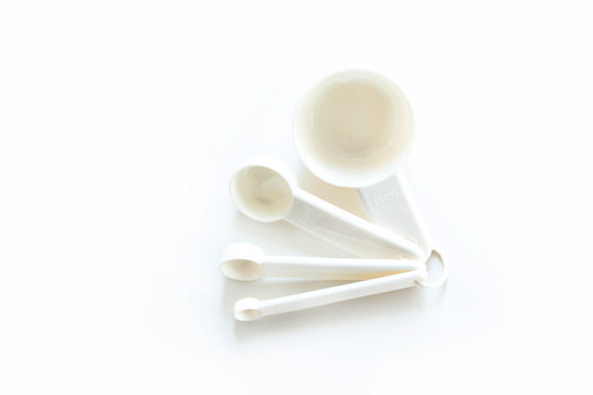 White measuring spoons on a white background