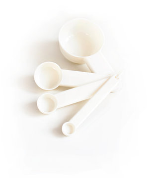 White measuring spoons on a white background