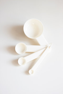 White measuring spoons on a white background
