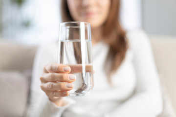 Woman drinking water at home