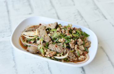 Pork liver spicy salad in white dish