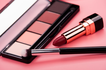 cosmetic products on a pink background