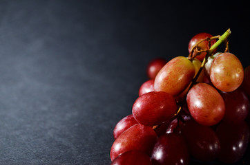 grapes on a branch close-up from the right edge on a gray background horizontal orientation
